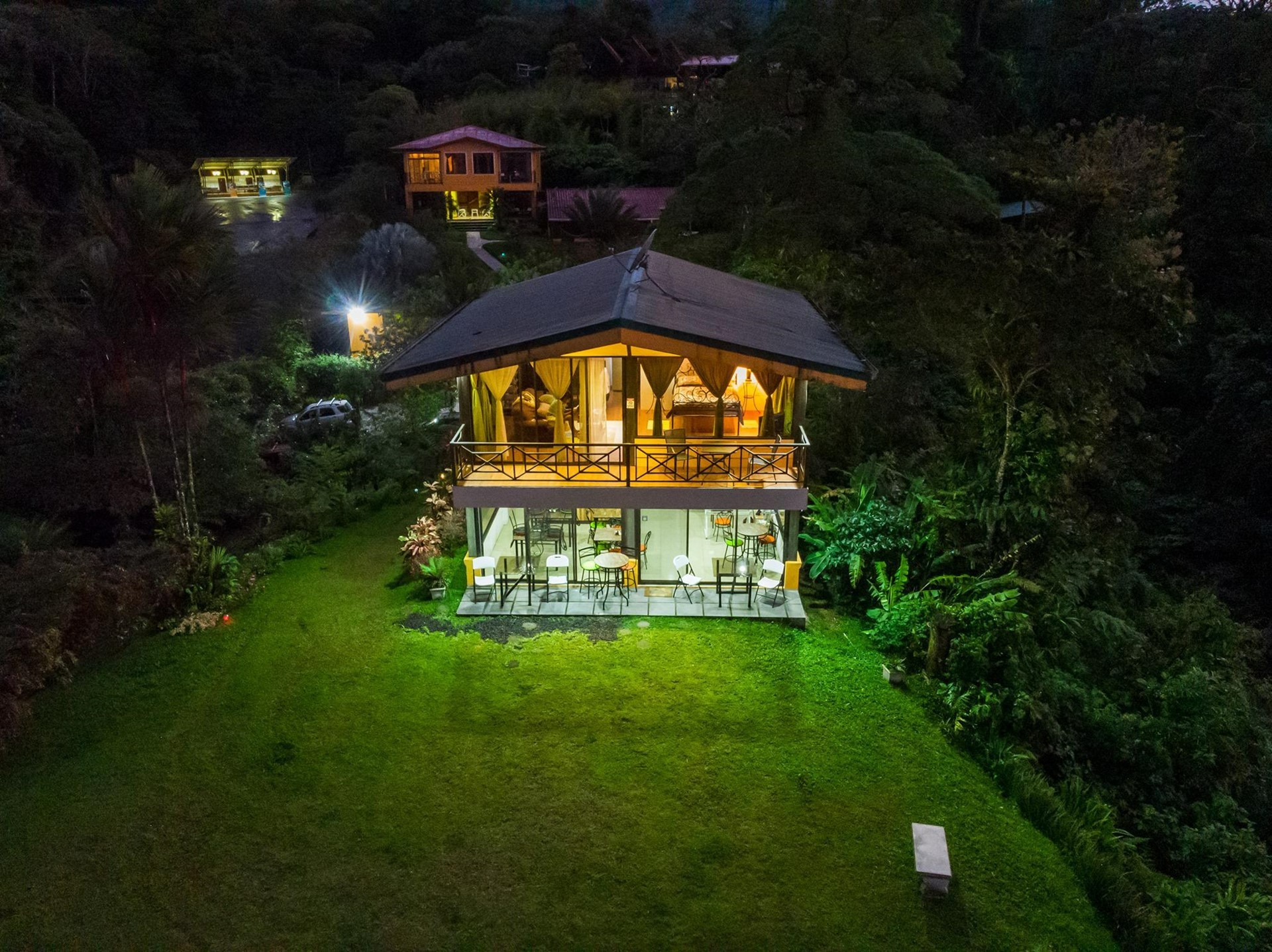 Arenal Garden Lodge illuminated hillside lodge at night in El Castillo, Hospitality Property Near Sky Adventures Costa Rica