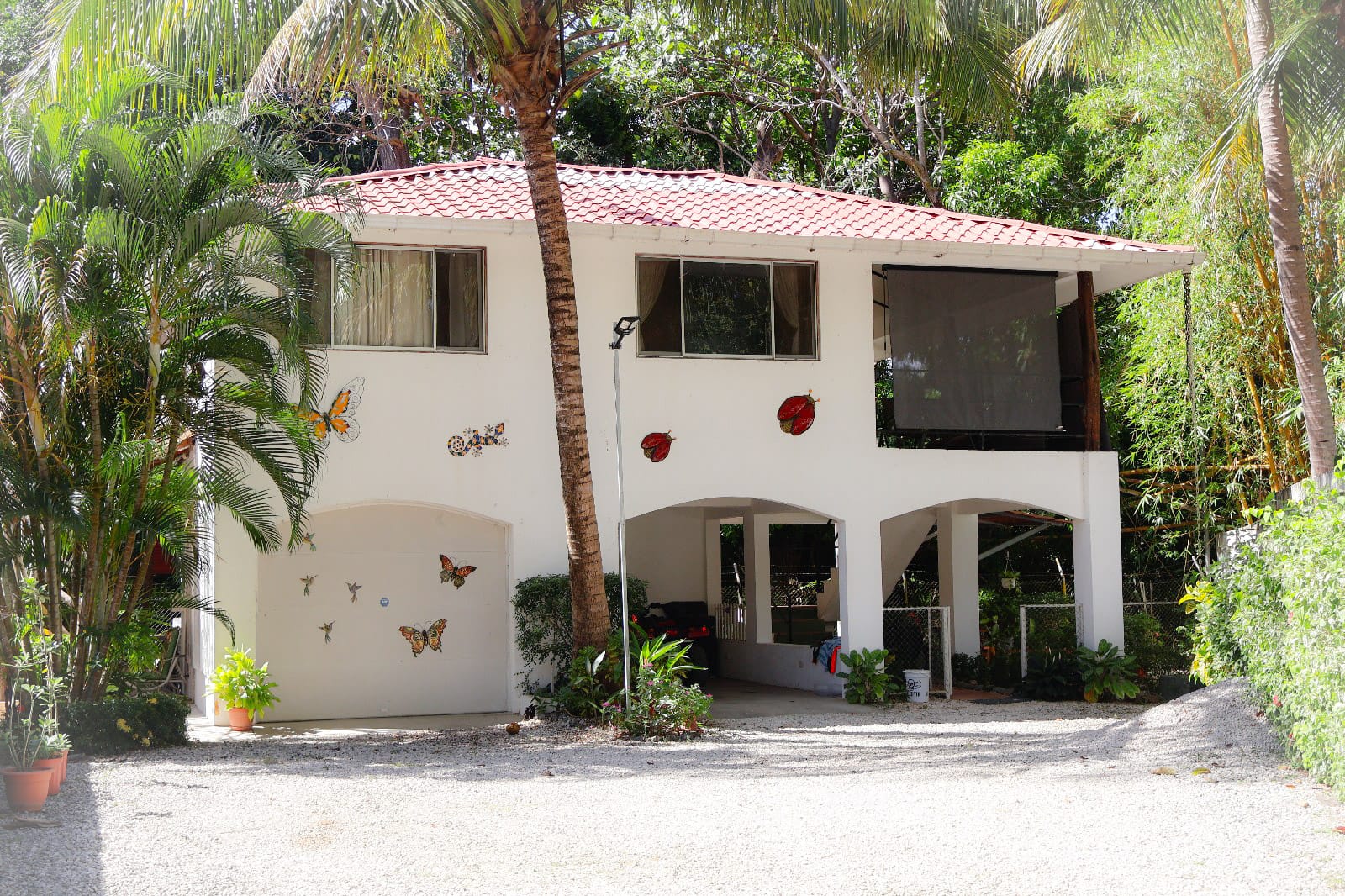 Exterior view of Casa Rincón Paraíso, a dual income property in Playa Potrero with two-level design and covered entry