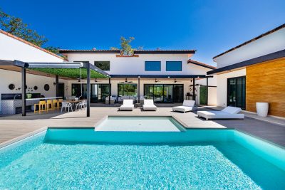 Los Almendros 51 terrace with pool and lounge chairs in Hacienda Pinilla, presented by Costa Rica Real Estate CR