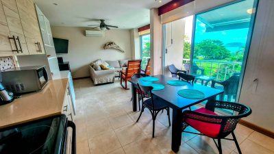 Interior dining and living area at Suenos del Mar 5 condo in Surfside Potrero with balcony and partial ocean views