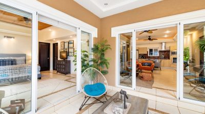 Covered patio seating with sliding glass doors into Bocaracá Unit 2 Playa Tamarindo Costa Rica living and kitchen areas