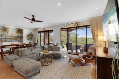 Elegant living room with large windows and terrace views at Bougainvillea 7105 in Reserva Conchal by Costa Rica Real Estate CR