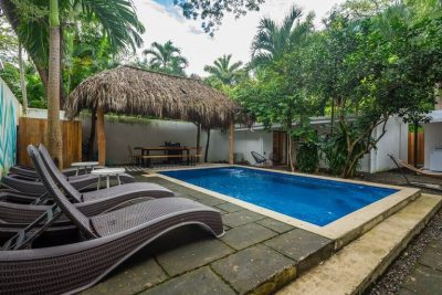 Pool and shaded lounge area at Casa Mar Agradable, a Surfside Playa Potrero home for sale near the beach