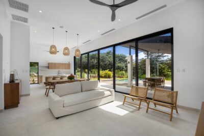 Modern living area at Casa Agua Salada with glass walls and pool views | Costa Rica Real Estate CR