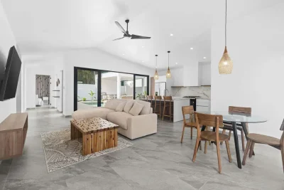 Modern open-concept living area in Casa Capi Capi with kitchen, dining space, and indoor-outdoor flow in Surfside Playa Potrero