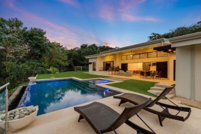 Casa Rico Playa Grande mountain-view home featuring pool and tropical greenery.