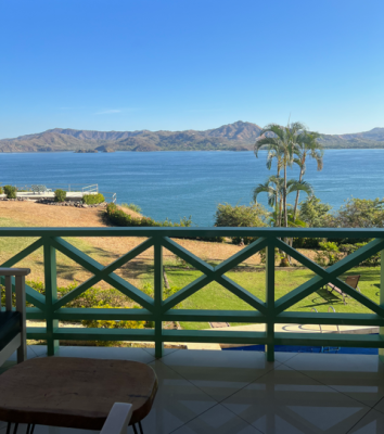 Balcony railing view from Punta Plata 513 overlooking the bay and ocean in Playa Flamingo