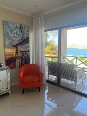 A modern, spacious living room in Punta Plata 513 with comfortable seating and a large sliding door to the balcony and ocean view.