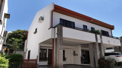 El Sandal 6 Tamarindo two-story home exterior with covered parking in gated community