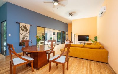 Casa Cultura Tamarindo open living area with wood floors and natural light, ideal eco retreat Tamarindo interior design
