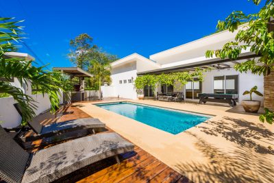 Modern Casa Del Rio home in Surfside featuring a private pool, sun deck, and covered outdoor living near Playa Potrero.