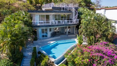 Aerial view of Casa Nalifos with saltwater pool, terraced garden, and ocean vista in Playa Flamingo, Costa Rica Real Estate Cr
