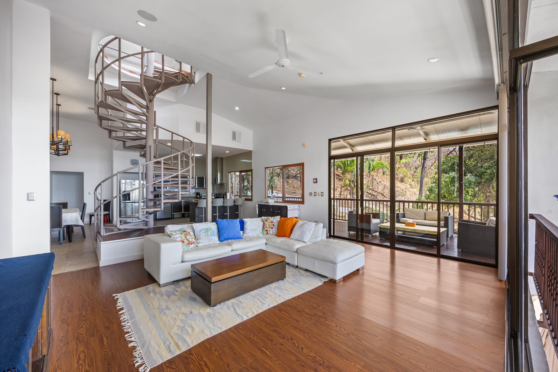 Living space with spiral staircase and stylish furnishings – Casa Veranera Playa Flamingo | Costa Rica Real Estate CR