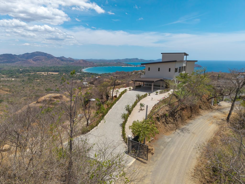 Gated driveway entrance to Casa Vista Escondida overlooking Playa Potrero Bay, a Costa Rica luxury estate in Pacific Heights.