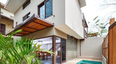 Modern townhome exterior with sliding glass doors, covered terrace, and private plunge pool in Tamarindo
