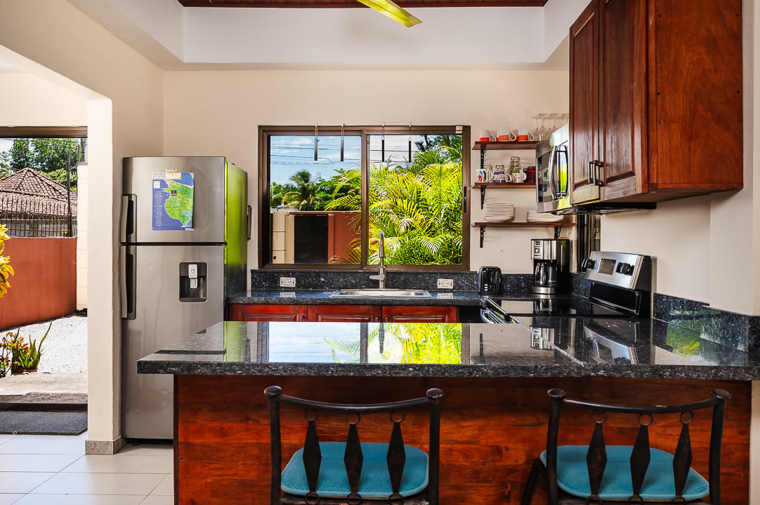 Casa Venturini kitchen with granite island, hardwood cabinets, Playa Potrero beach-area home with private pool Costa Rica