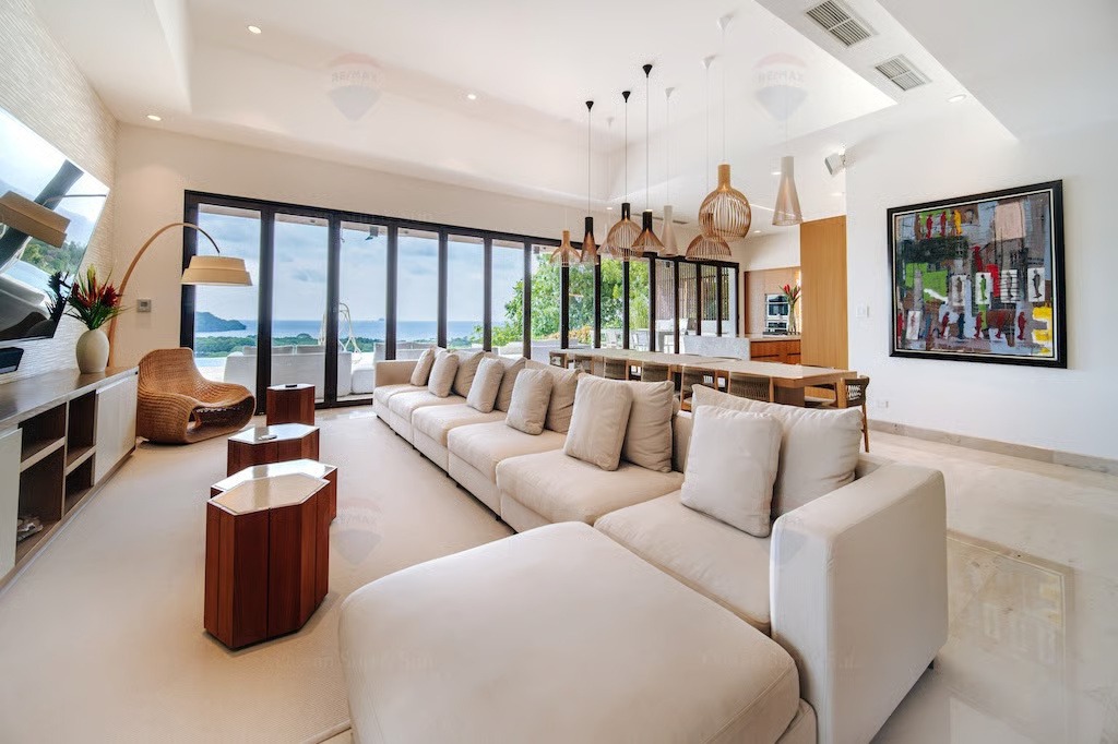 Spacious living room with long sectional sofa and ocean views at Cortez Amarillo — Costa Rica Real Estate CR