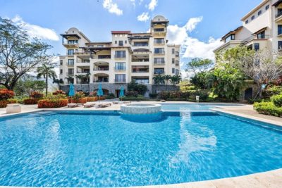 Ground-floor condo at Malinche 115B in Reserva Conchal with resort pool, landscaped gardens, and luxury residences