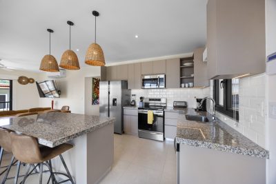 Modern kitchen at Terraced Flats 7512 Las Catalinas with granite countertops | Costa Rica Real Estate