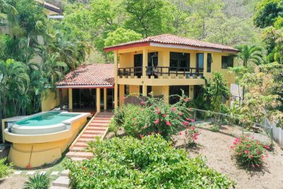 Casa Marazul two-story yellow home with infinity pool and tropical garden in Playa Prieta | Costa Rica Real Estate CR
