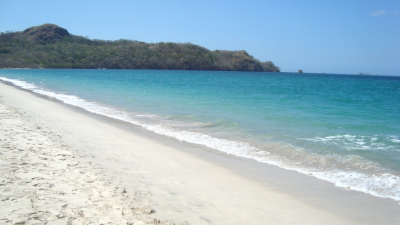 Playa Conchal Costa Rica community beach with clear turquoise water, soft white sand, and natural greenery