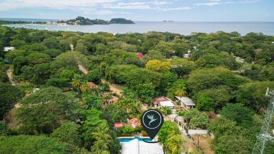 Almond Tree Surfside Potrero investment property shown from above, surrounded by tropical canopy near the coast