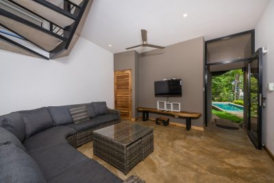 Modern living room in Casa Chaperon Tamarindo Park with private pool view and indoor-outdoor access
