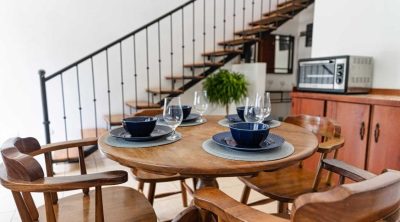 Loft-style dining area at Condo Pura Vida in Playa del Coco, featuring open living space and stairs just minutes from the beach
