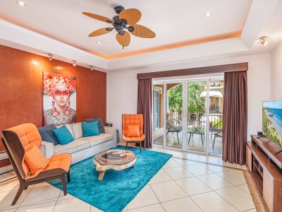Interior living room at BocaRaca #9, a luxury 2-bedroom condo half a block from Tamarindo Beach with balcony access.