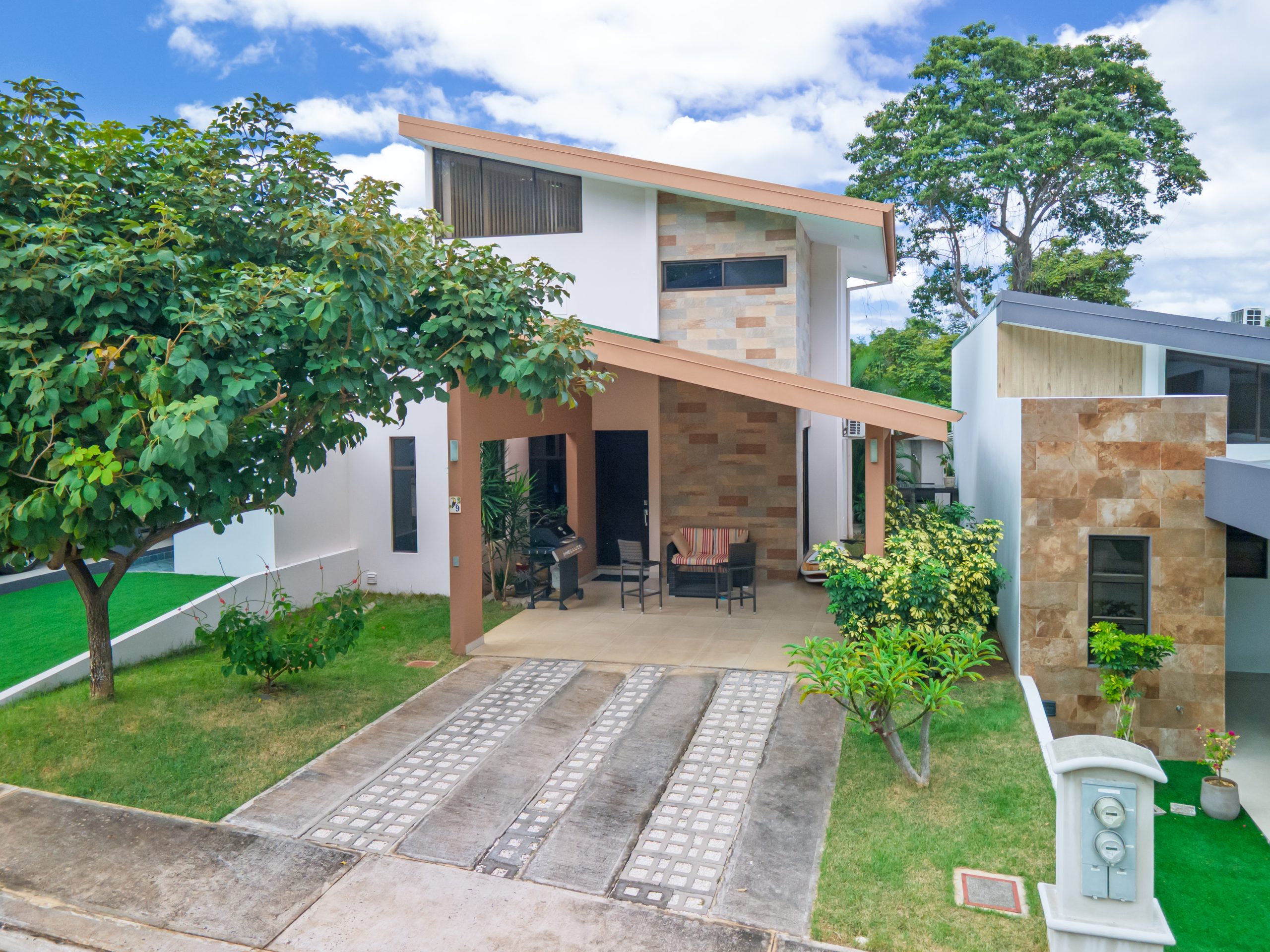 Front exterior of Monte Hermoso 9 gated home in Playas del Coco with covered patio and landscaped driveway