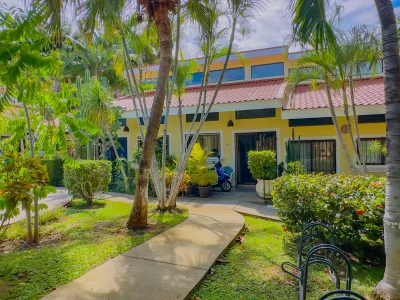 Loft-style condo exterior at Sea Bird 8 in Las Palmas, Playas del Coco, surrounded by tropical landscaping and walkable to the beach
