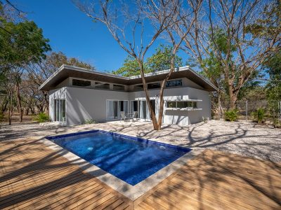 Modern Villa Dionisio with private pool, wood deck, and contemporary architecture surrounded by trees in Guanacaste, Costa Rica