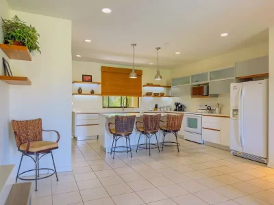 Renovated kitchen with island and modern finishes at Pacífico L1213 condo in Playas del Coco, Costa Rica