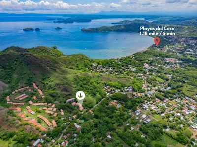 Aerial view near Serena Suites B1 showing Playa Ocotal bay, green hills, and the community between Coco and Ocotal, Costa Rica
