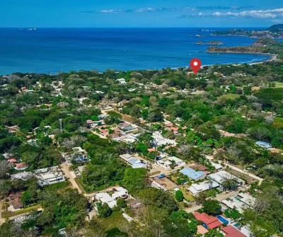 Aerial view of Surfside Playa Potrero neighborhood with beach and coastline near AA-10 Lot, Guanacaste