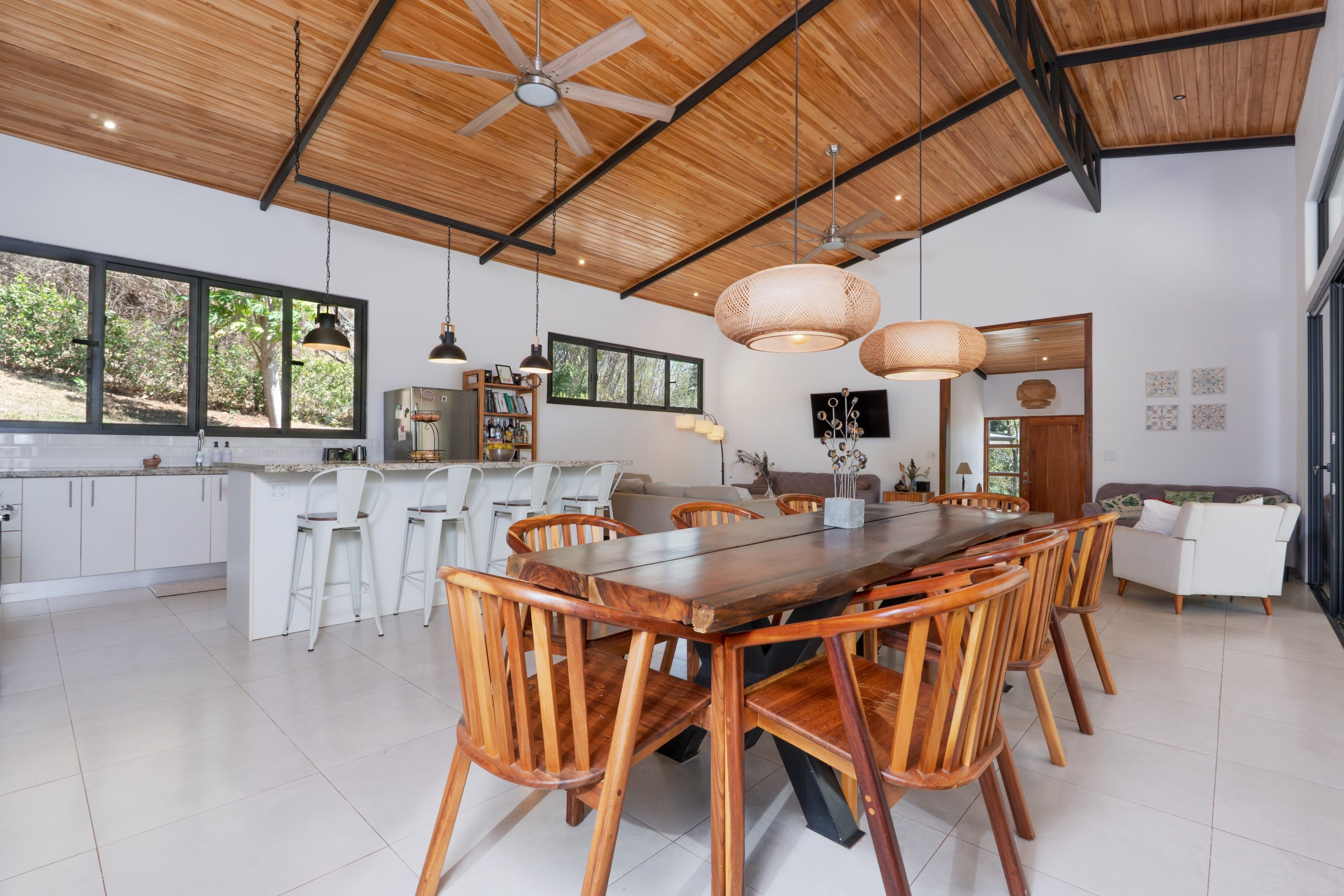 Open dining area at Casa Los Sueños with wood ceilings and large table, a home with guest house near Tamarindo Costa Rica