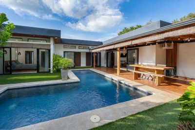 Pool courtyard at Casa Botánica Tamarindo with covered outdoor dining and separate guest casita in Calle Uno.