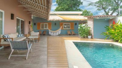 Covered terrace with seating, hammock, and pool at Villa Salome in Tamarindo Park, showing outdoor living space and garden