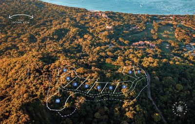 Aerial view of Guayacán Real Lot 10 homesite layout in Reserva Conchal overlooking the Pacific Ocean and surrounding tropical forest