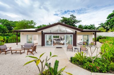 The Point 19 Avellanas modern home exterior with garden and patio seating