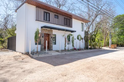 Casa Jacaranda Playa Grande modern home exterior with wood accents and entry path, Playa Grande investment property