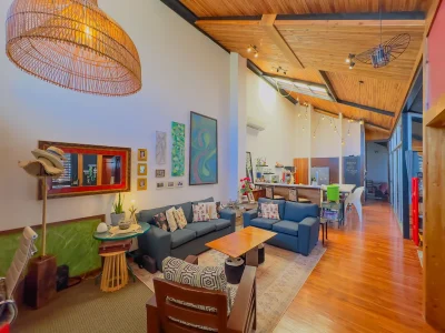 Casa Pasiflora open-concept living room with vaulted wood ceiling and lounge area in a Playas del Coco house