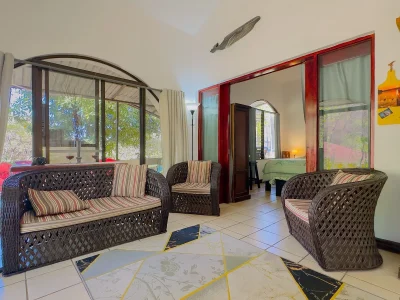 Horizon Lounge Villa 7 Playas del Coco interior with seating area and bedroom access, condo in Costa Rica