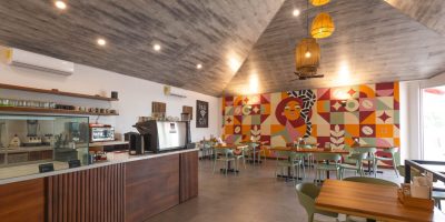 Nita Coffee Potrero interior dining area with bar seating and mural in cafe Playa Potrero Costa Rica