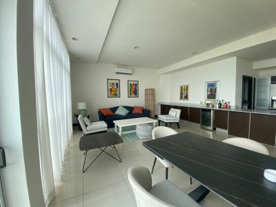 Bright living area inside Pacific Park Penthouse Tamarindo with modern seating, dining space, and large windows in this Tamarindo luxury condo.