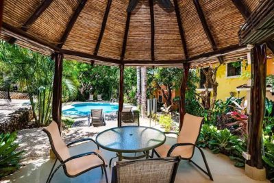 Pueblo del Mar 14 outdoor seating area with garden and pool view in Tamarindo