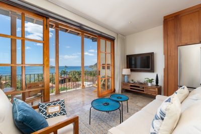 42 Carlota living area with open doors to balcony and ocean view, oceanview condo Las Catalinas
