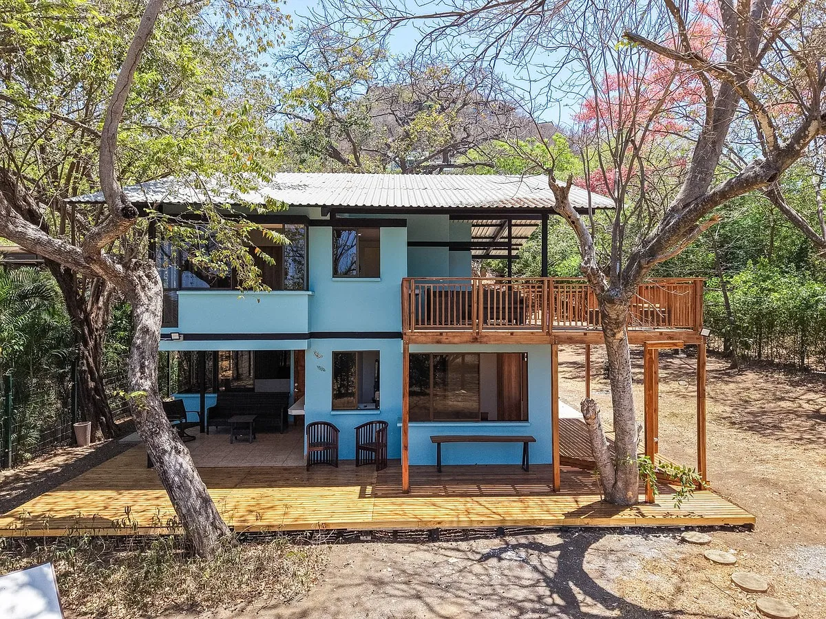 Botanikos duplex exterior with wooden deck and trees, income property near Liberia Costa Rica