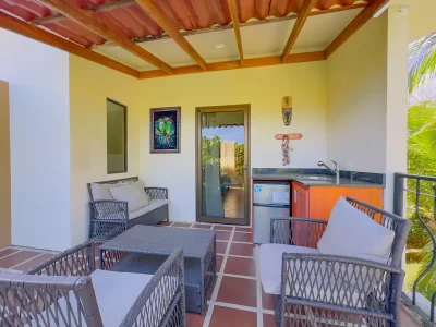 Outdoor terrace seating area at Jade A13 Las Palmas condo in Playas del Coco with lounge furniture and kitchenette