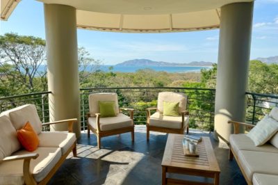 La Perla 134 Tamarindo terrace seating with panoramic ocean and jungle views overlooking Playa Grande coastline